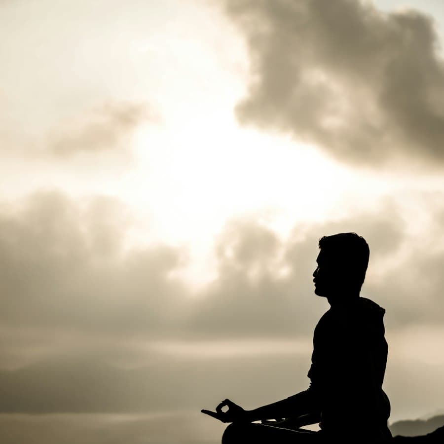 A person seated in meditation on a hill